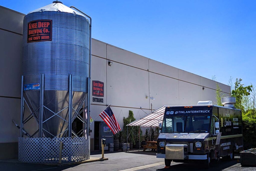 Knee Deep Brewery in Auburn exterior barrel and food truck