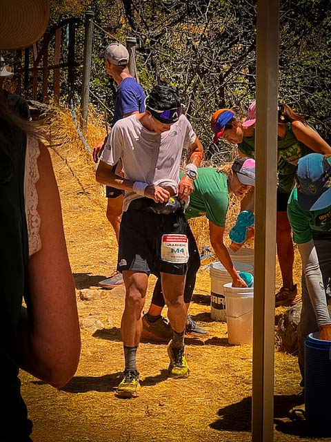Western States runner at an aid station
