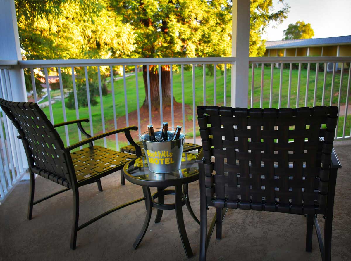 the-foothills-patio-and-chairs - Foothills Motel The Foothills Motel patio and chair overlooking green grass and trees